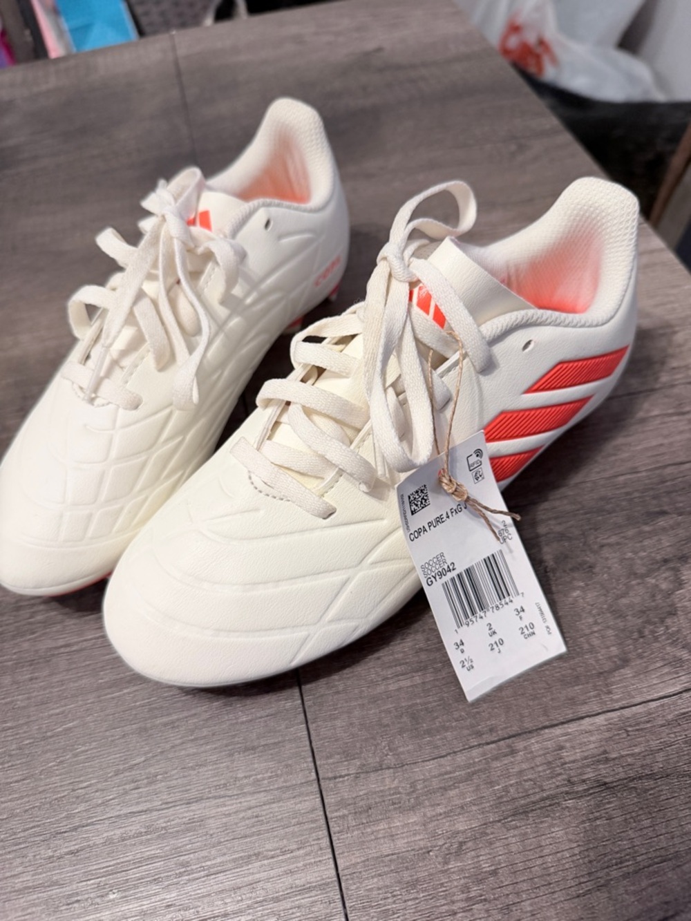 adidas White Soccer Cleats with Coral Three-Stripes